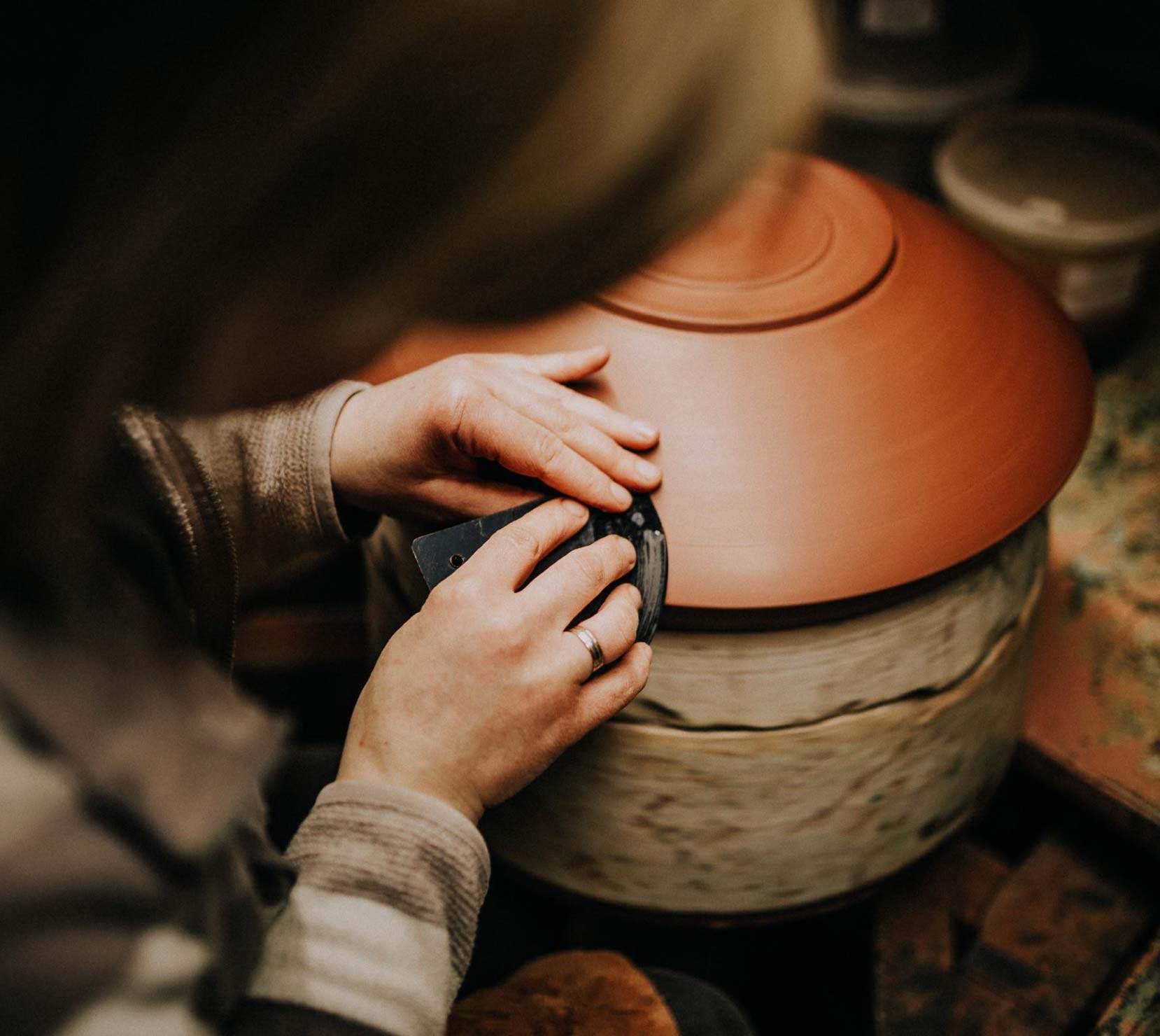 Polishing a clay bowl using a turning table