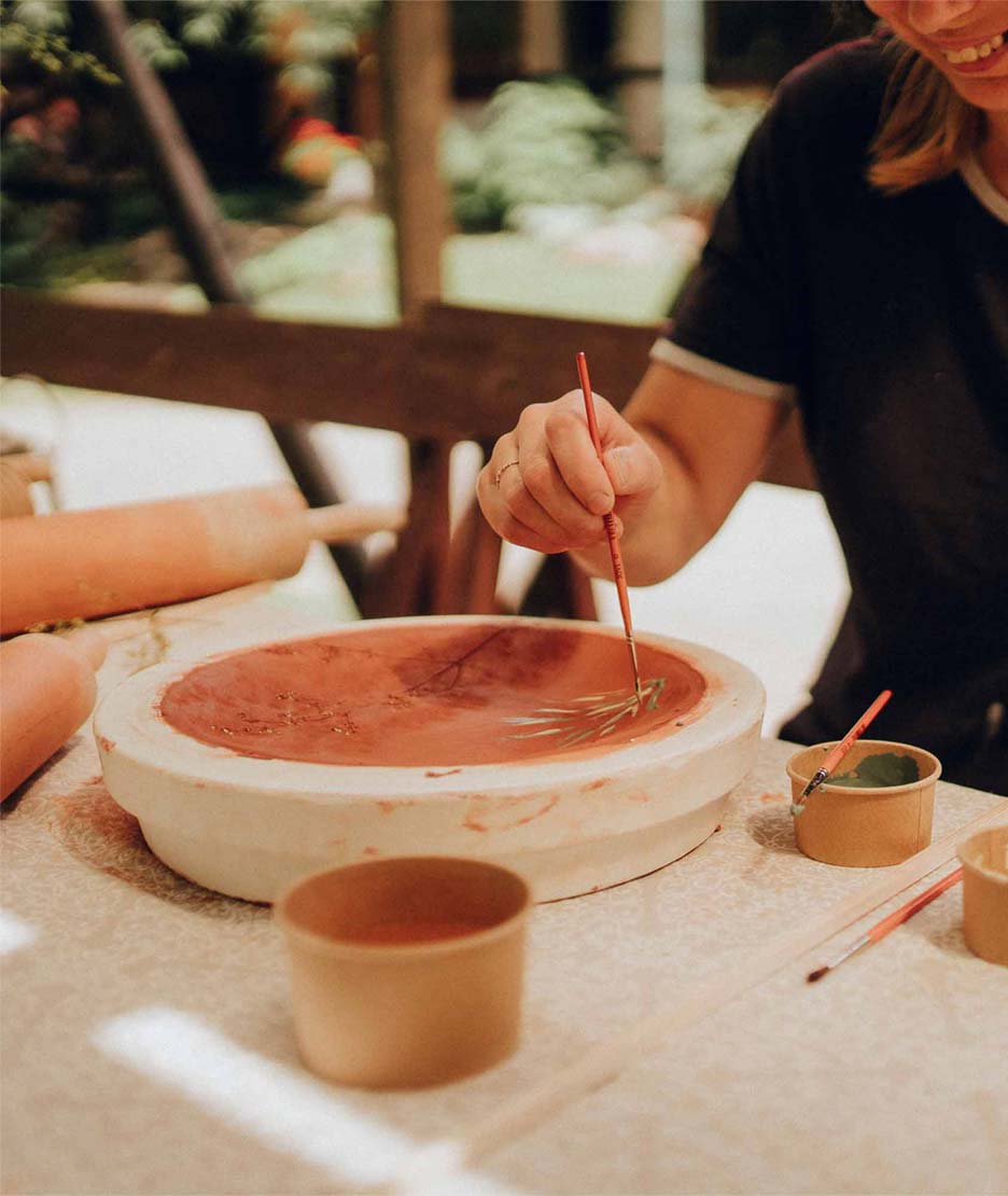 Painting a plate during the ceramics workshop