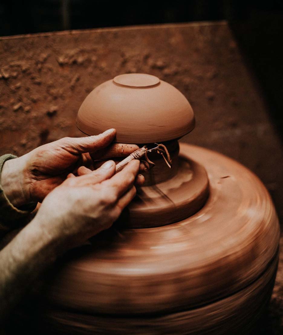 Trimming the edge on a clay bowl