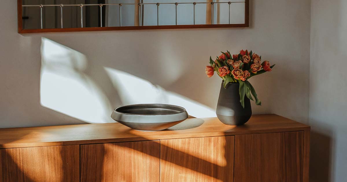 Bedroom dresser with clay bowl and flower vase